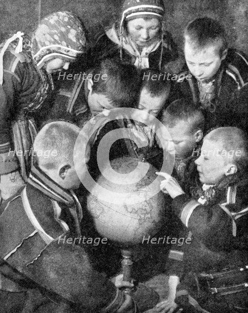 Lapp children looking at a globe, 1936. Artist: Unknown