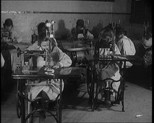 Young Female Civilians Operating Sewing Machines in an Arts Class, 1920. Creator: British Pathe Ltd.