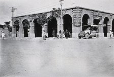Two men in a car outside the Wellcome pharmaceutical depot in the Middle East, c1910.. Creator: Unknown.