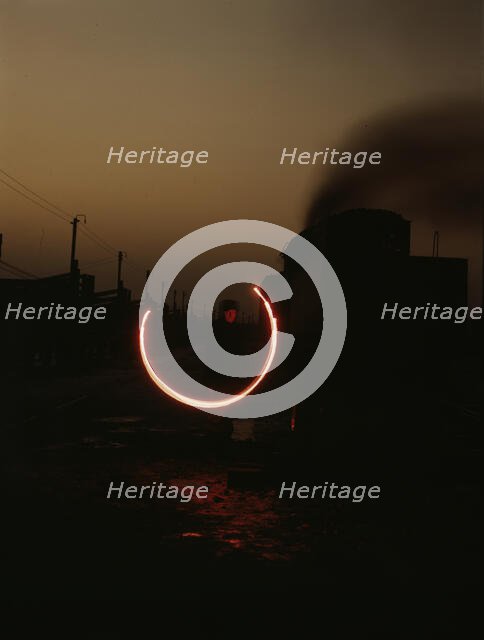 Indiana Harbor Belt RR, switchman demonstrating signal with a "fusee"..., 1943. Creator: Jack Delano.