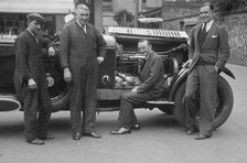 Four men posing beside a Minerva car. Artist: Bill Brunell.