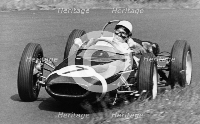 Stirling Moss taking a bend in a racing car, (c1960-c1961?). Artist: Unknown