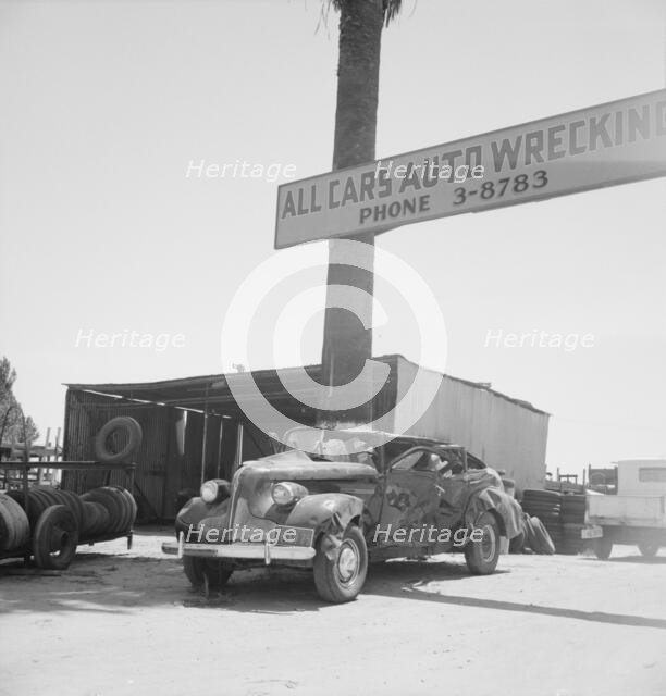 Used car lots and auto wrecking establishments, U.S. 99,  Near Tulare, California, 1939. Creator: Dorothea Lange.