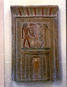 Door shaped stela representing Senouret and his wife in front of their offerings, made in polychr…