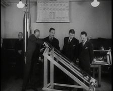 Interior Shot of a British Man Inserting Various Items in a Long Thin Glass Time Capsule..., 1938. Creator: British Pathe Ltd.