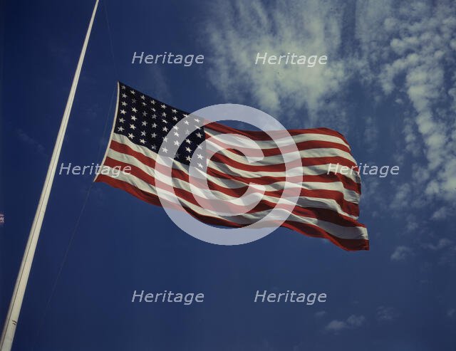 High above, over a true "home of the brave," the floating folds of the Star..., Fort Knox, Ky., 1942 Creator: Alfred T Palmer.