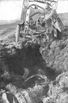 'Au Volant; Camion demoli, pres de Verdun, par un obus de 210: le radiateur detache est..., 1916. Creator: Unknown.