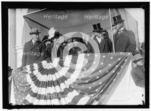 Woodrow Wilson and wife Ellen with unidentified on viewing stand, between 1910 and 1914. Creator: Harris & Ewing.