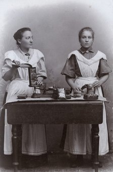 Two girls measuring coffee at the Dutch coffee shop, Landskrona, Sweden, 1910. Artist: Unknown