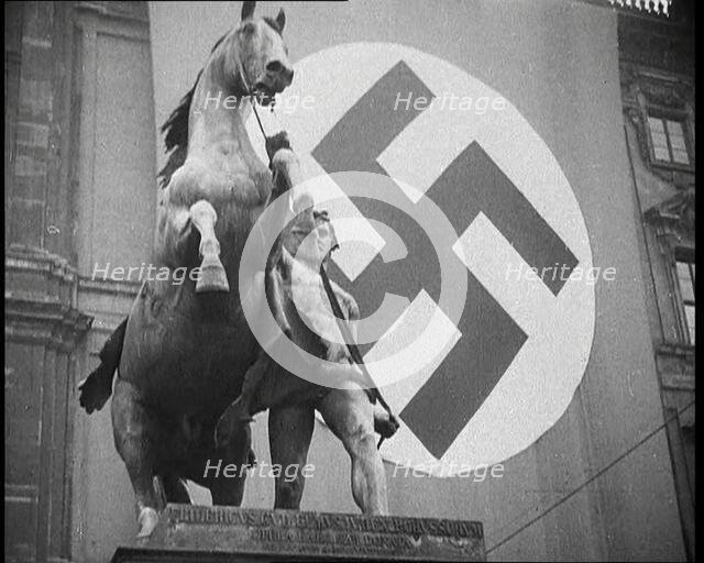 Statue With a Nazi Flag Behind it, 1930s. Creator: British Pathe Ltd.