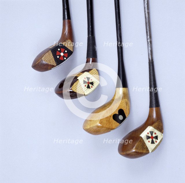 Spalding wooden clubs with coloured 'Fancy Face' inserts, American, 1920s. Artist: Spalding