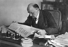 Vladimir Ilyich Ulyanov (Lenin), Russian Bolshevik revolutionary, reading Pravda, 1918. Artist: Unknown
