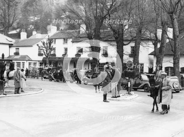 Pedestrians and riders outside the Burford Bridge Hotel, Surrey, (c1930s?). Artist: Unknown