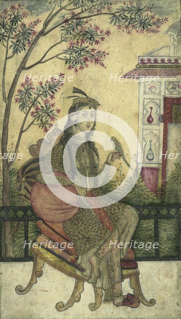 Portrait of a woman, seated, holding a small bird. Creator: Unknown.