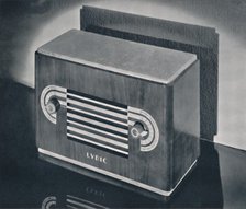 'A midget radio cabinet in wood veneer, with aluminum grill and dials', 1935. Artist: Dana Merrill.