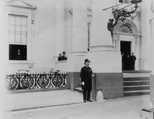 Policeman standing guard at entrance to White House, between 1889 and 1906. Creator: Frances Benjamin Johnston.