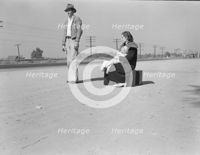 Young family, penniless, hitchhiking on U.S. Highway 99, California, 1936. Creator: Dorothea Lange.