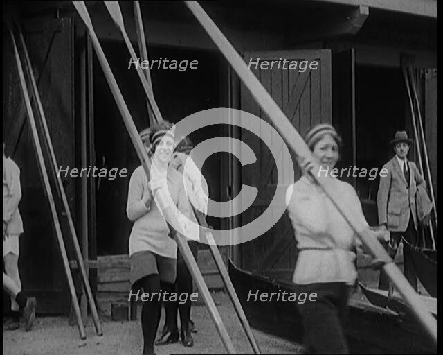 Young Female Civilians Wearing Sport Outfits Carrying Rowing Blades Arriving for a Rowing Class,1920 Creator: British Pathe Ltd.