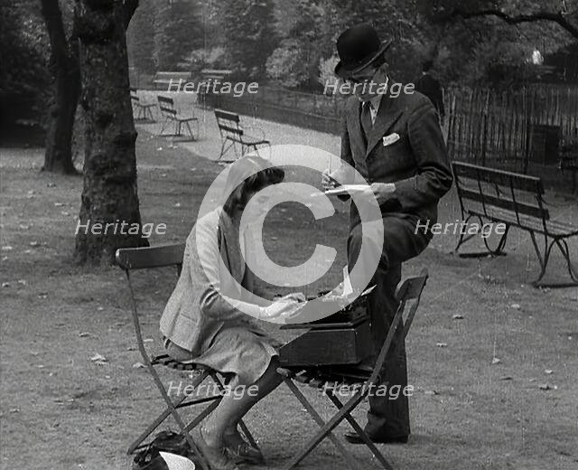 A Man and Woman Taking Notes in a Park, 1941. Creator: British Pathe Ltd.