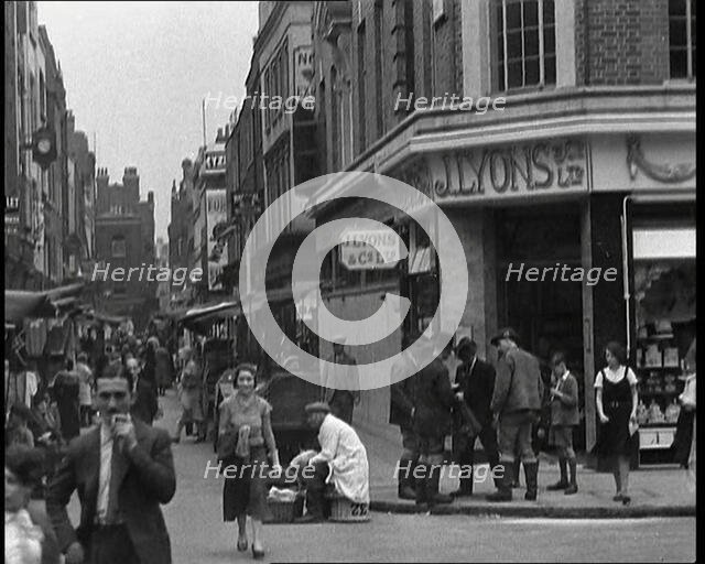 People Walking Past Shops, 1930s. Creator: British Pathe Ltd.
