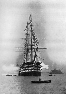 HMS 'Duke of Wellington' firing a Royal Salute as flagship at Portsmouth, Hampshire, 1896.Artist: Symonds & Co