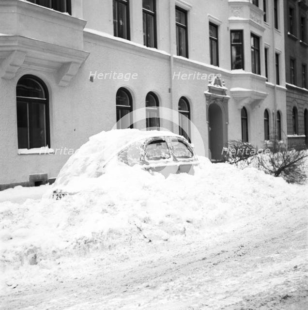 Snow in a car at telephone booth in Stockholm, Sweden, January 1954.
 Creator: Unknown.
