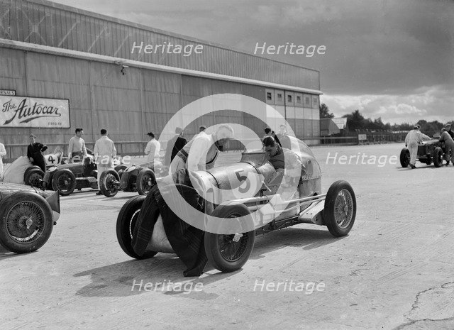 Cars of George Harvey-Noble, Charles Goodacre and Bert Hadley, BRDC 500 Mile Race, Brooklands, 1937. Artist: Bill Brunell.