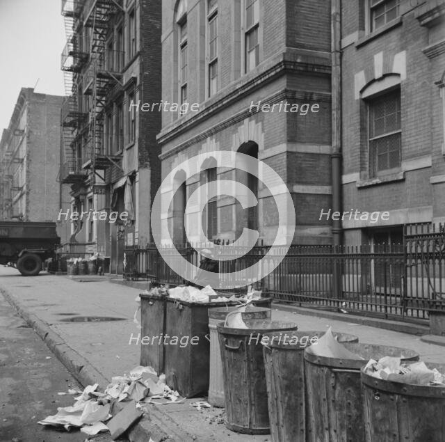 Street scene showing open trash cans along the curb, New York, 1943. Creator: Gordon Parks.