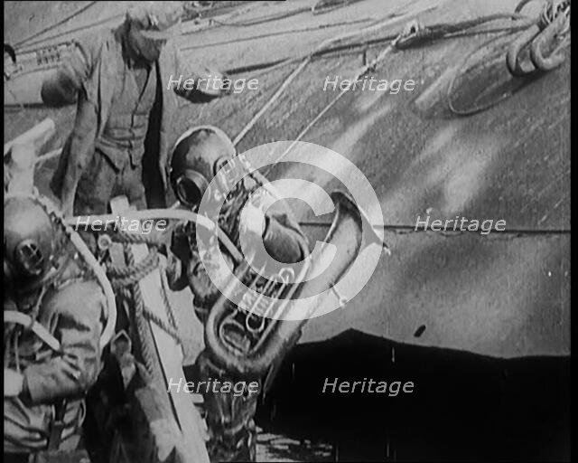 A Diver Coming up from the Sea Carrying a Tuba, 1929. Creator: British Pathe Ltd.