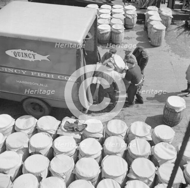 Barrels of fish on the docks at Fulton fish market ready to be shipped to retailers, New York, 1943. Creator: Gordon Parks.