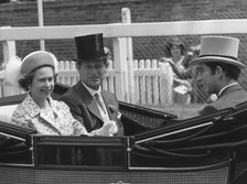 The Royal party driving down the course on the first day of Royal Ascot, 17th June 1975.  Creator: Unknown.