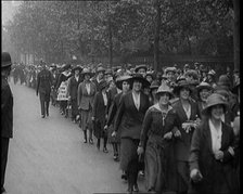 Striking Tea Shop Ladies Marching Down the Road, Flanked by Police, 1920. Creator: British Pathe Ltd.