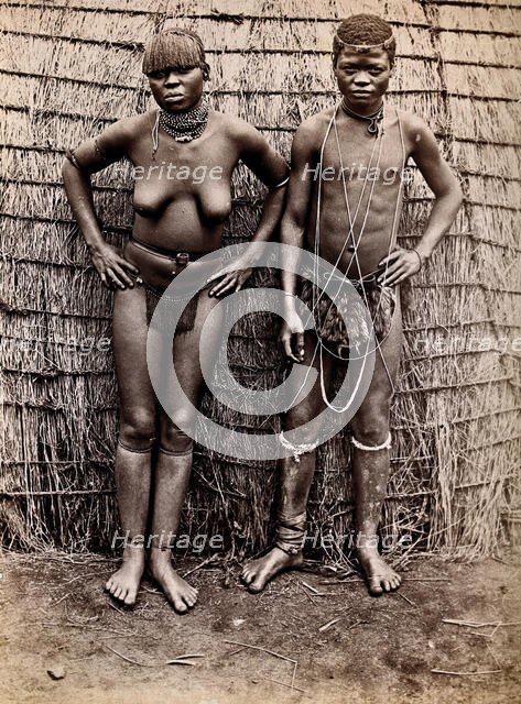 Africa: an African woman and man in front of a kraal hut, 19th century. Creator: Unknown.