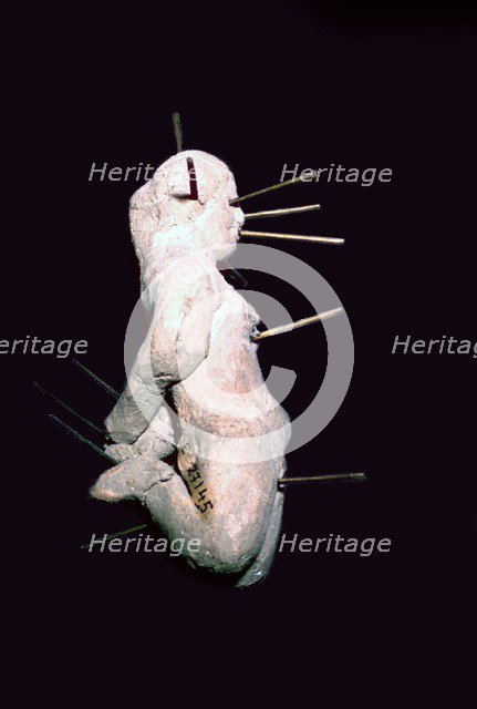 Egyptian clay figure stuck with pins. Artist: Unknown