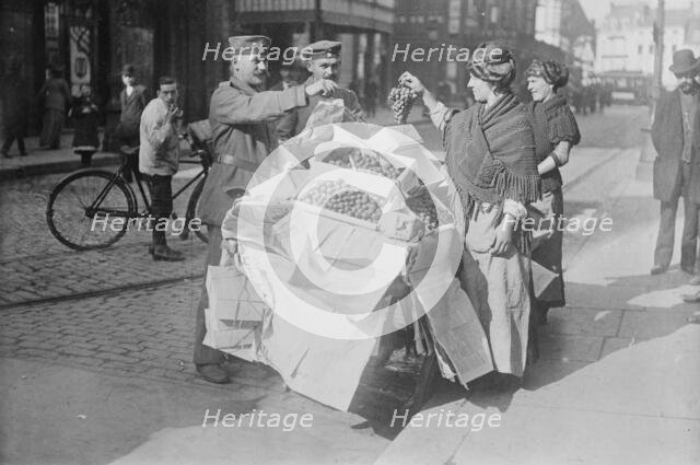 German soldiers buying fruit, Belgium, 1915. Creator: Bain News Service.