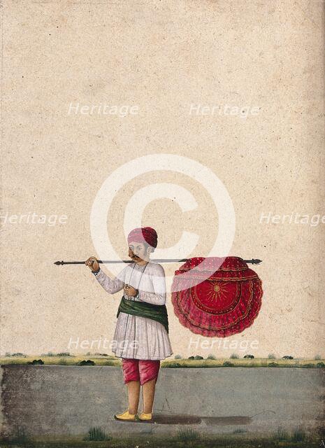 An Indian bearer holding a large, richly decorated fan or banner..., (between 1800 and 1899?). Creator: Unknown.