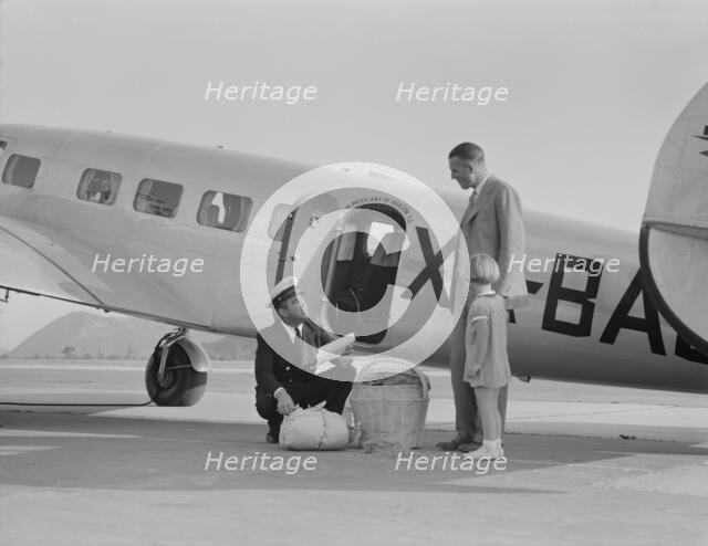 Plant quarantine inspector examining baggage, Glendale, California, 1937. Creator: Dorothea Lange.