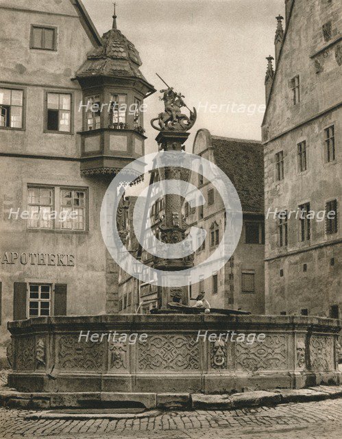 'Rothenburg o. d. T. - St. George's Fountain - Marien-Apotheke', 1931. Artist: Kurt Hielscher.