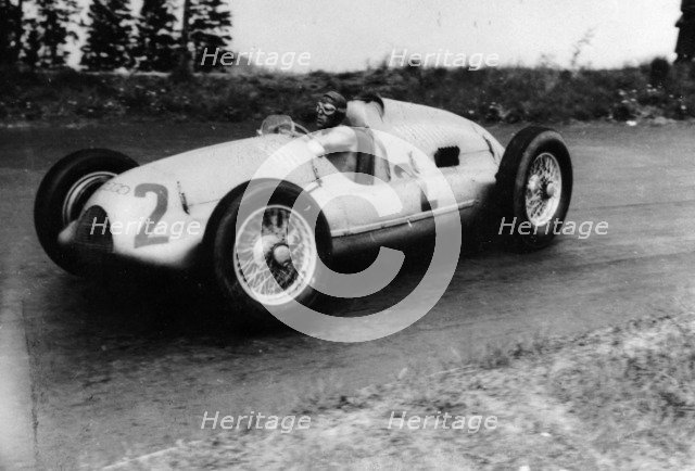Tazio Nuvolari driving a 3 litre Auto Union in a Grand Prix, 1939. Artist: Unknown