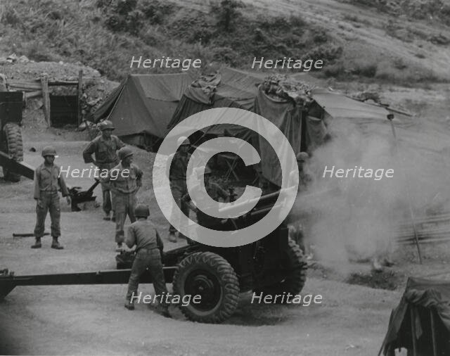 Vietnamese artillerymen fire from a mountain position during field training, 1962. Creator: United States Army.