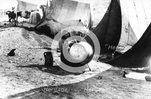 Man with a large pot, Bistrita Valley, Moldavia, north-east Romania, c1920-c1945. Artist: Adolph Chevalier
