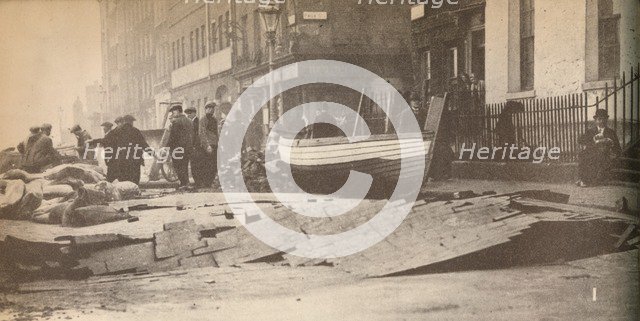 'Damage caused on the Victoria Embankment when the Thames burst its banks and caused a number of fat Artist: Unknown.