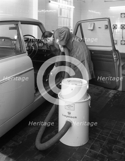 Laycock Vacacar vacuum cleaner in use at an Esso garage, Sheffield, South Yorkshire, 1965. Artist: Michael Walters