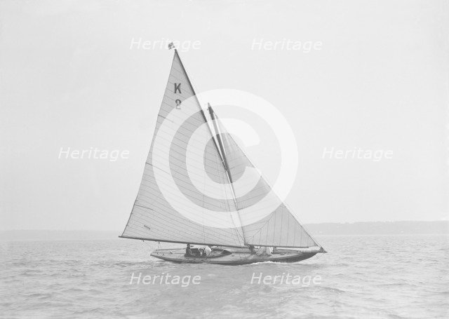 The 7 Metre yacht 'Ithnan' (K2) sailing close-hauled, 1911. Creator: Kirk & Sons of Cowes.