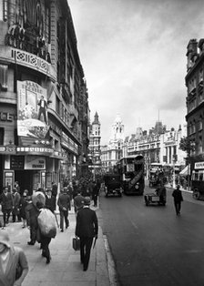 People walking past the Astoria Theatre in Charing Cross Road, Westminster, London, early 1930s.   Artist: George Davison Reid