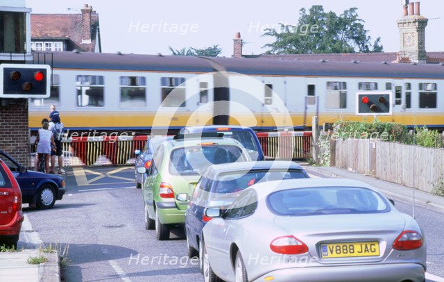 Traffic queue at level crossing in Brockenhurst, Hampshire. Artist: Unknown.
