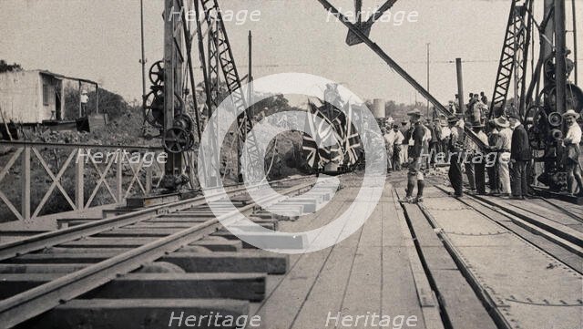 Zimbabwe: people and a flag-covered train at the opening of Victoria Bridge, 1905. Creator: J Lomas.