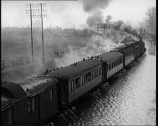 Train Driving Through Flooded Fields and Tracks, 1926. Creator: British Pathe Ltd.
