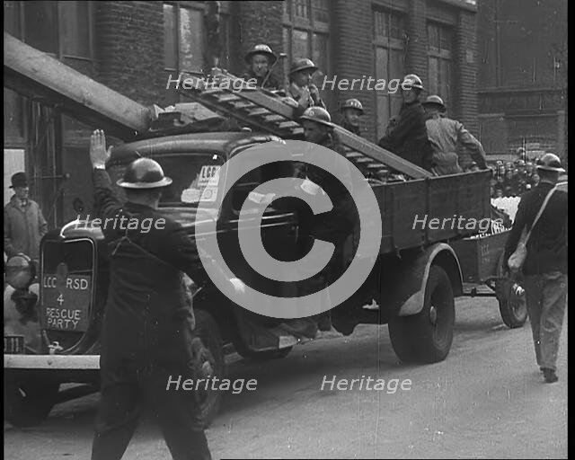 British Air Raid Wardens Arriving at a Phoney Air Raid Scene, 1940. Creator: British Pathe Ltd.