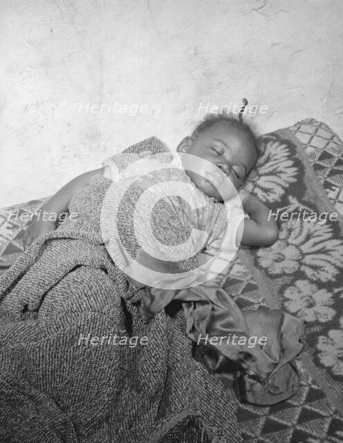 Child seriously ill from an infection caused by a rat bite in her home..., Washington, D.C., 1942. Creator: Gordon Parks.
